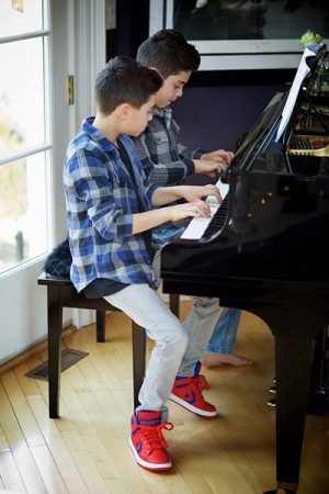 Private Piano lessons in NYC. Twins playing piano
